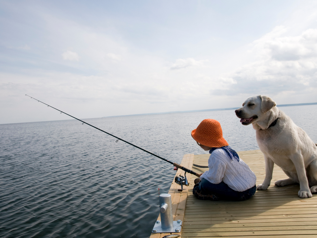 little girl and dog fishing