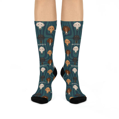 A pair of blue socks with a modern unisex design featuring illustrations of Borzoi dogs in various poses.