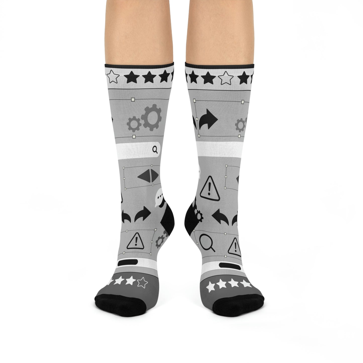 A pair of gray socks with a design of stars, gears, and other graphic elements related to user experience (UX) design.